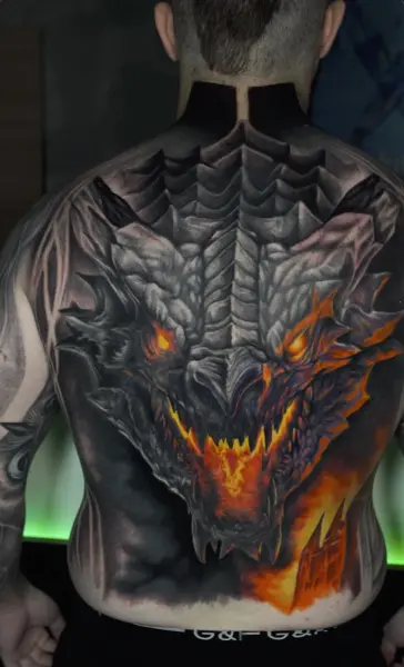 Dragón a color en espalda completa con efectos de fuego